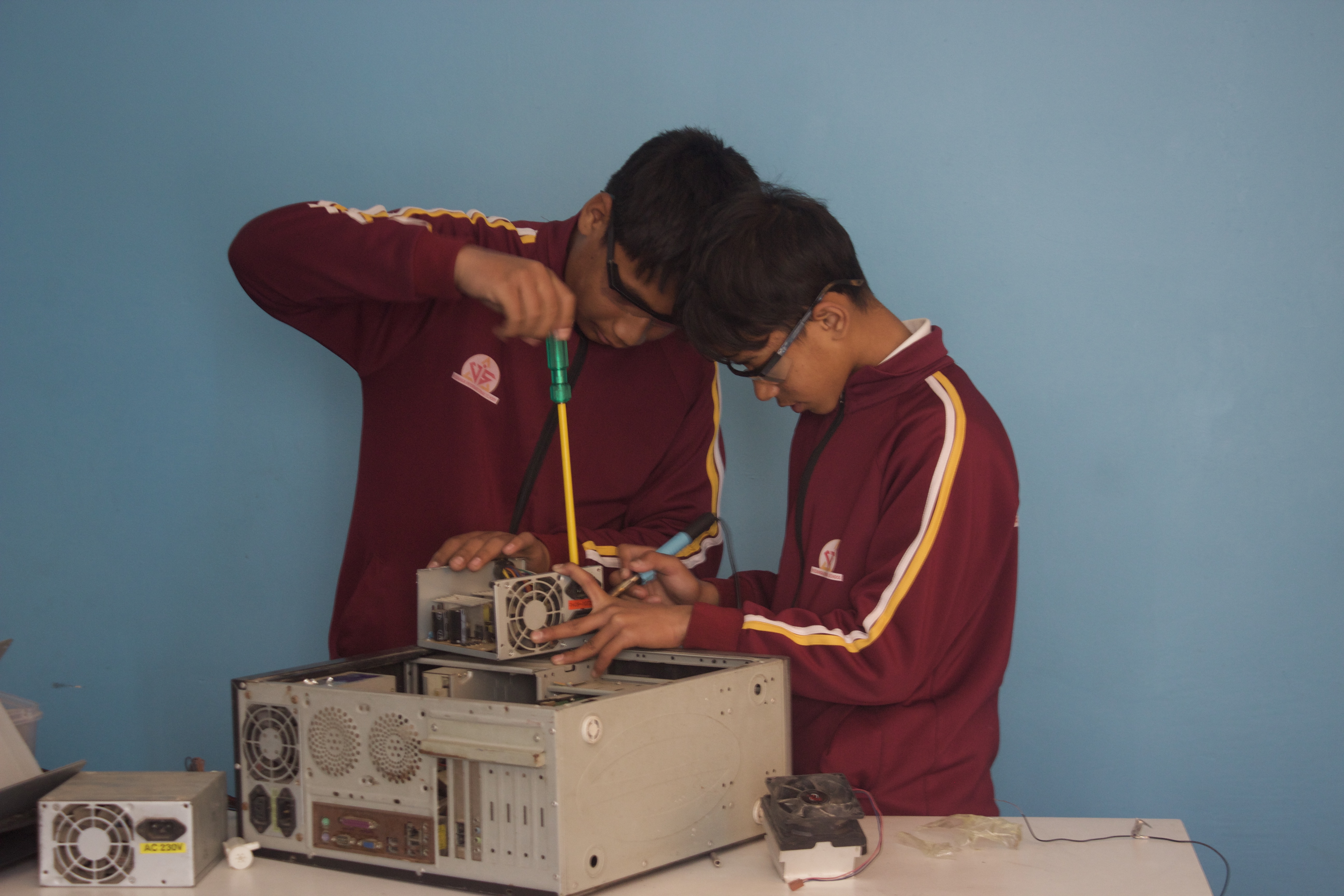 Students working together on a robotics project at Vedanga